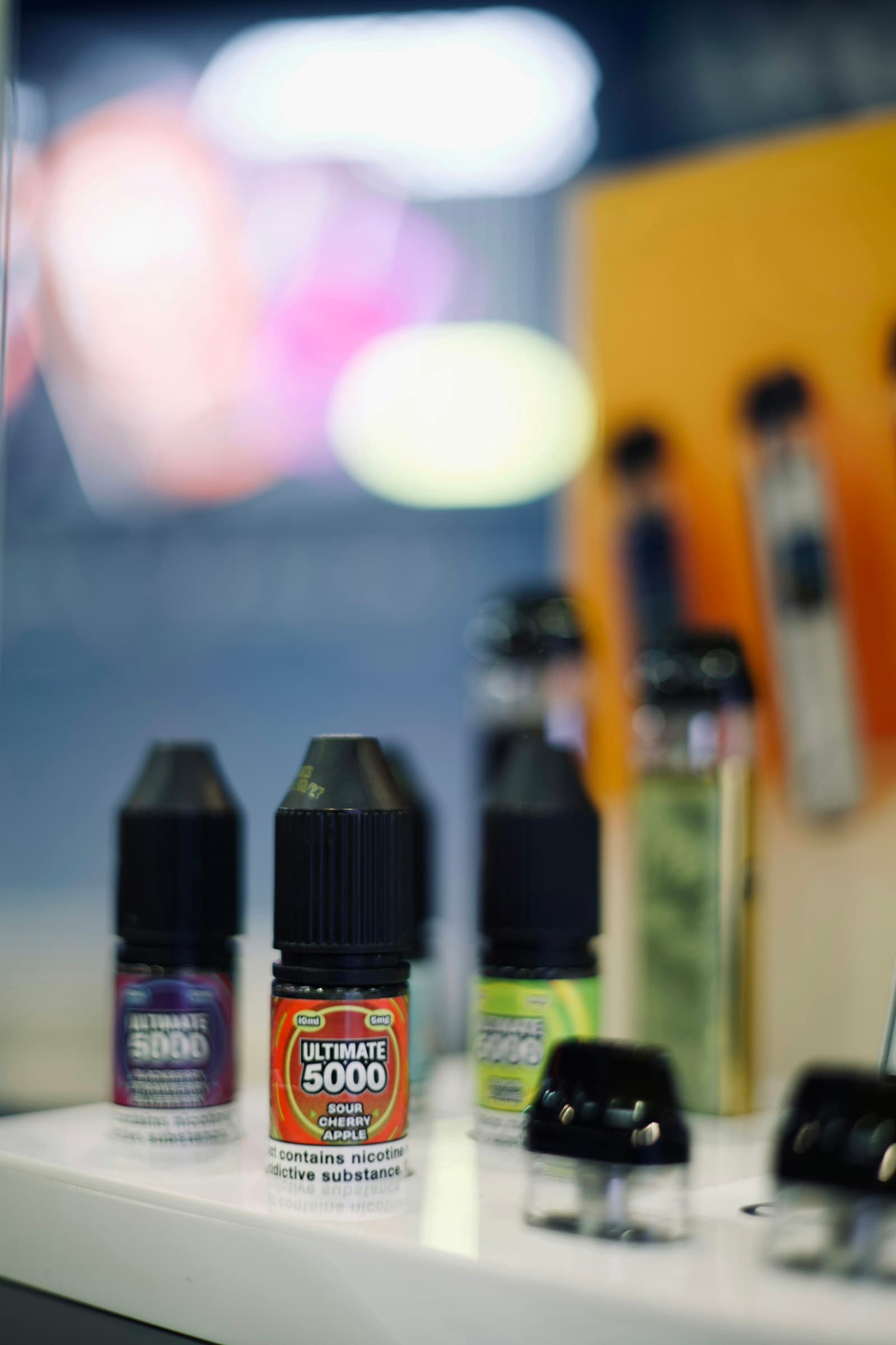 Small 10ml nicotine salt e-liquid bottles in a range of fruit flavours displayed on a shop shelf